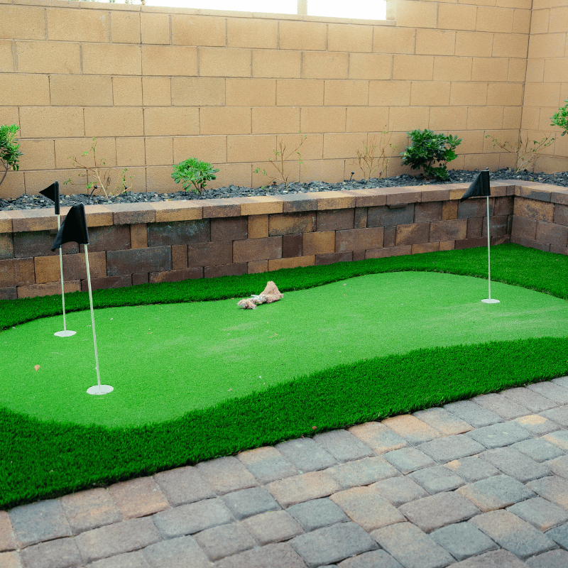 putting green and retaining wall planter in small backyard