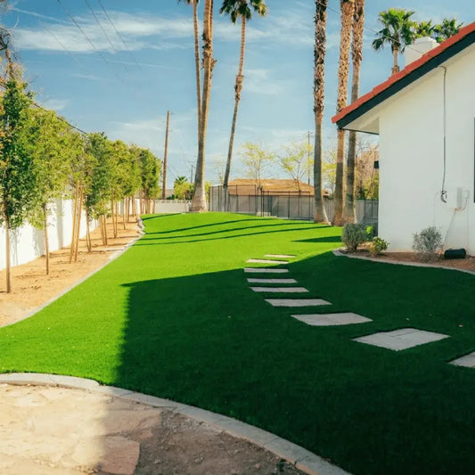 A paver stone walkway leading from backyard gate to turf area in the backyard